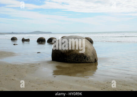 The Moeraki Boulders on Koekohe Beach on the Otago coast of New Zealand's South Island. They are a popular tourist attraction for those travelling SH1 Stock Photo