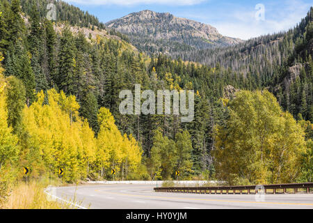 Highway road on mountain with golden aspen trees in Colorado Stock Photo