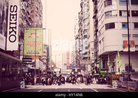 A busy street in Hong Kong, China. Hong Kong is known for its busy urban streets and iconic harbor skyline. Stock Photo