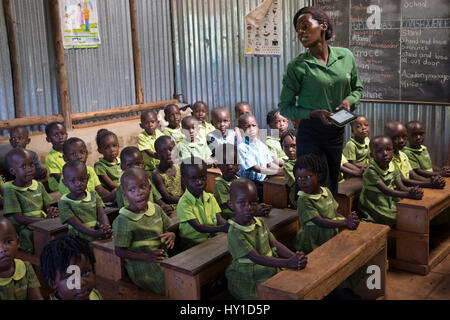 A teacher and her pupils at a Bridge International Academies primary school in Mpigi, Uganda. Stock Photo