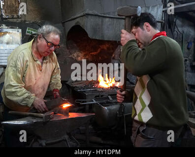Smiths heated iron piece cut in workshop Stock Photo