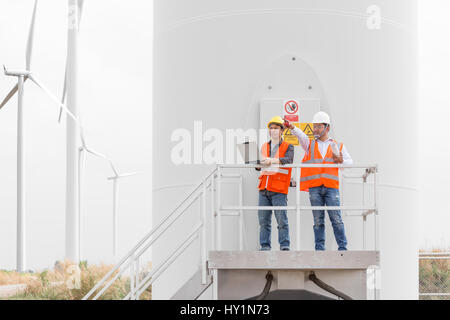 Electrical engineers and technician working in wind turbine power generator station with laptop computer Stock Photo