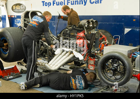 Santa Pod, UK - October 29, 2011: Mechanics working on a top fuel funny car at the Flame and Thunder drag-racing event at Santa Pod Raceway in Northam Stock Photo