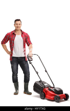 Full length portrait of a male gardener with a lawnmower isolated on white background Stock Photo