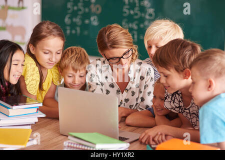 Teamwork over the teacher's laptop Stock Photo