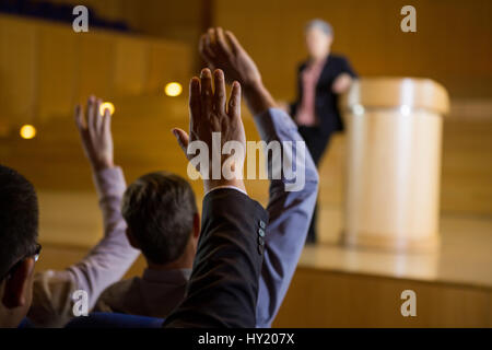 Business executives actively participating in conference center Stock Photo