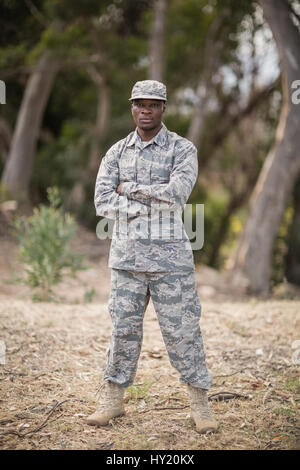 Military soldier standing with arms crossed in boot camp Stock Photo