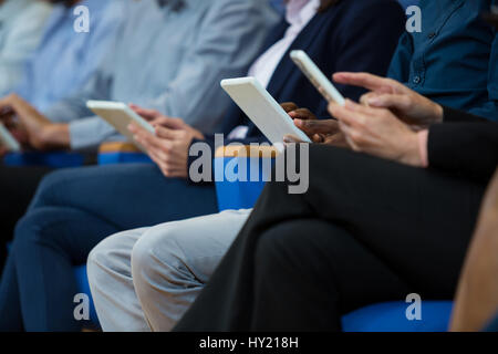 Business executives participating in a business meeting using digital tablet at conference center Stock Photo