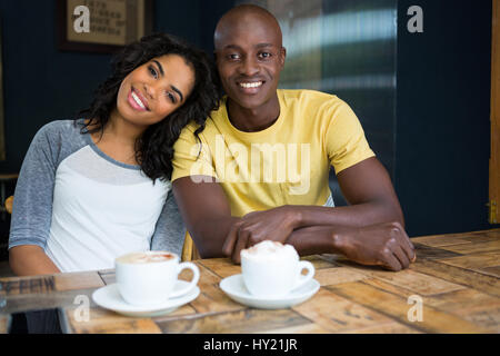 Portrait of happy loving couple sitting at table in coffee shop Stock Photo