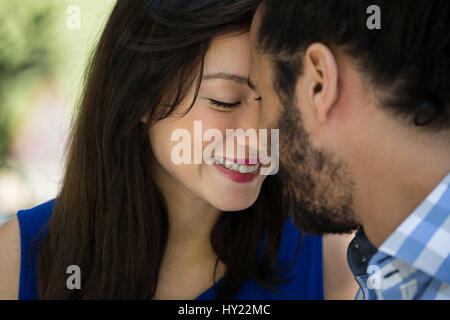 Close-up of romantic young couple in park Stock Photo