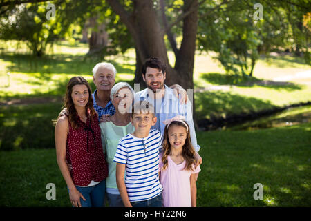 Portrait of multi generation family standing in park Stock Photo