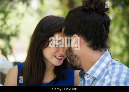 Close-up of romantic young couple spending leisure time in park Stock Photo