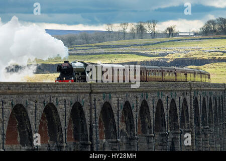 Ribblehead, North Yorkshire, UK. 31st March 2017. The iconic steam locomotive LNER class A3 60103 Flying Scotsman, travels over the Ribblehead Viaduct. The train is travelling this route, taking part in the celebrations marking  the re-opening of the Settle Carlisle line. Credit: Ian Lamond/Alamy Live News Stock Photo