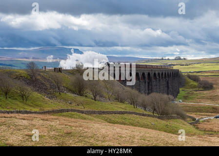 Ribblehead, North Yorkshire, UK. 31st March 2017. The iconic steam locomotive LNER class A3 60103 Flying Scotsman, travels over the Ribblehead Viaduct. The train is travelling this route, taking part in the celebrations marking  the re-opening of the Settle Carlisle line. Credit: Ian Lamond/Alamy Live News Stock Photo