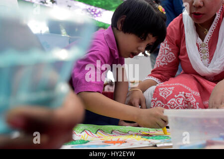 DHAKA, BANGLADESH – APRIL 01, 2017: Bangladeshi autistic child paints as he attends an art camp on the day of World Autism Awareness Day in Dhaka, Bangladesh. Stock Photo