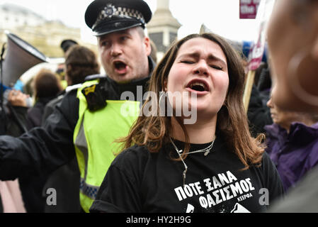 London, UK. 1st Apr, 2017. An anti-fascist demonstrator sings and dances as police attempt to move the protesters on. Far-right groups Britain First and the EDL took to the streets in central London to protest in response to the recent Westminster terror attack. Credit: Jacob Sacks-Jones/Alamy Live News. Stock Photo