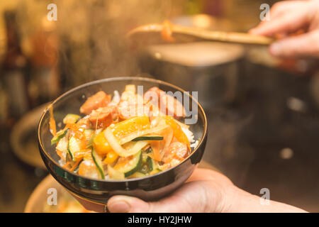 Rice, vegetables, and meat in freshly cooked meal. Stock Photo