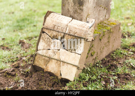 Grave yard tomb stone in misty, green cemetery. Stock Photo