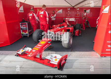 Goodwood, UK - July 13, 2013: Ferrari Formula 1 race car and mechanics at the Festival of Speed event in Goodwood, UK Stock Photo