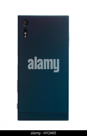 Smartphone in turquoise colour, rear cover with lens and flash lamp. Stock Photo