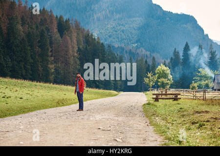Young man standing on a path in the great outdoors Stock Photo