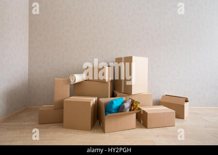 Cardboard boxes in new empty room Stock Photo