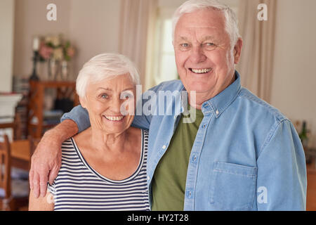 Close-up of happy senior couple standing in the living room Stock Photo