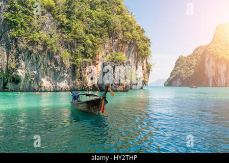 Beautiful landscape of rocks mountain and crystal clear sea with longtail boat at Phuket, Thailand. Summer, Travel, Vacation, Holiday concept. Stock Photo