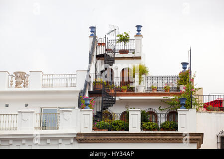 Three balconies connected with a winding staircase filled with plants in pots, in Seville, southern Spain, Europe. Stock Photo