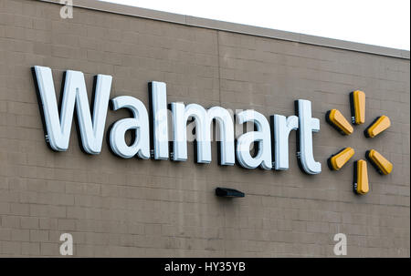 Walmart sign is seen on the wall of one of their many stores. Stock Photo