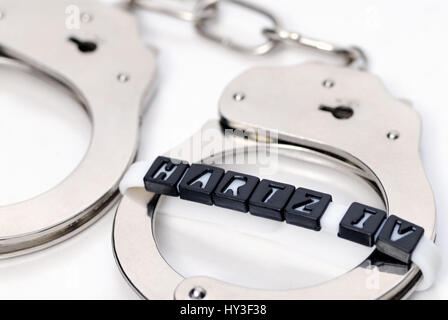 Handcuffs and Hartz IV stroke, working duty for Hartz IV receiver, Handschellen und Hartz IV-Schriftzug, Arbeitspflicht für Hartz IV-Empfänger Stock Photo