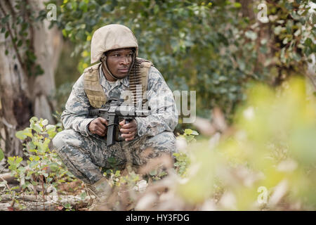 Military soldier guarding with a rifle in boot camp Stock Photo