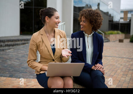 Portrait of two businesswomen interacting with each other in the office premises