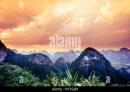 Sunset over karst landscape by Yangshuo in China Stock Photo