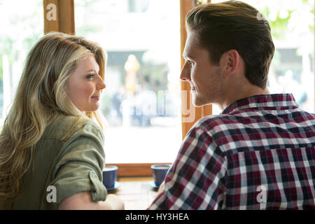 Loving young couple looking at each other in coffee house Stock Photo