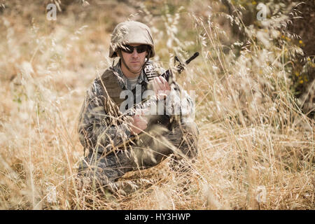 Military soldier guarding with a rifle in boot camp Stock Photo