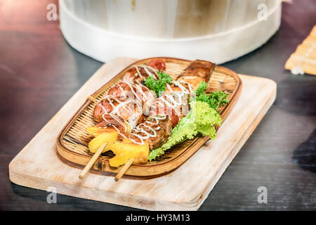 Homemade Bacon Wrapped Hot Dogs with Onions and Peppers. Stock Photo