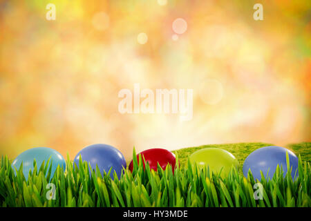 Grass growing outdoors against glowing lights behind field Stock Photo