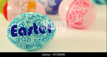 Easter greeting against colorful easter eggs on white background Stock Photo