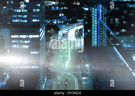 High angle view of glowing road amidst building in city at night Stock Photo