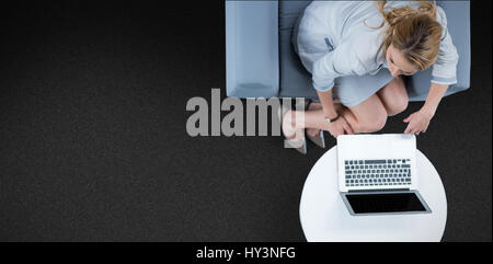 Woman on her laptop against black background Stock Photo