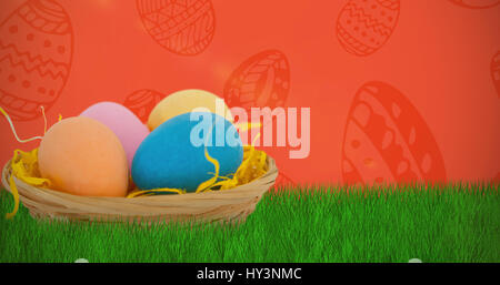 Colorful Easter eggs in wicker basket  against red background Stock Photo