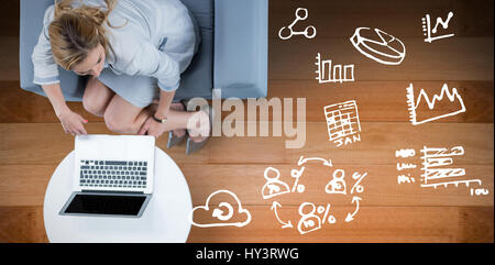 Woman on her laptop against wooden floor Stock Photo