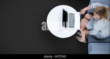 Woman on her laptop against black background Stock Photo