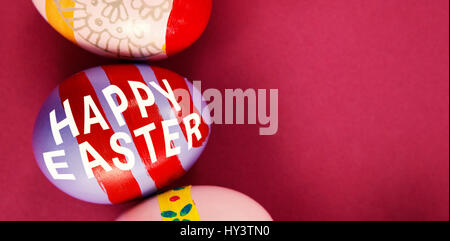 Easter greeting against various easter eggs arranged on pink background Stock Photo