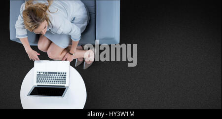Woman on her laptop against black background Stock Photo