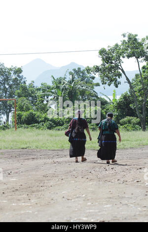 Local woman dressed with traditional national clothes walking in Guatemala villages. Stock Photo