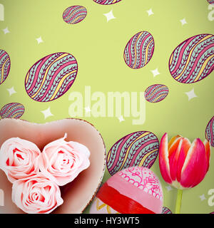 Rose in a heart against painted easter eggs on white background Stock Photo