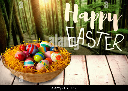 Easter greeting against tall trees growing in forest Stock Photo