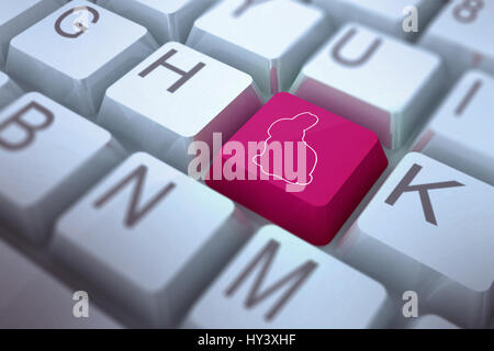 rabbit against pink key on keyboard Stock Photo